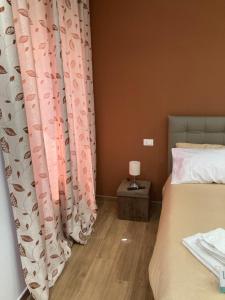 a bedroom with two beds and a curtain at Piccolo paradiso suite in pieno centro Castel di Sangro in Castel di Sangro