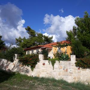 een huis achter een stenen muur bij Beautiful Cottage sea view near the beach Greece in Lixouri