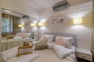 a living room with a couch and a mirror at Black Sea Dolphin Apartment in Varna City +9 photos