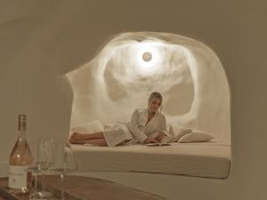 a woman sitting on a bed in a bubble shaped room at Maison Dalidaz in Vóthon