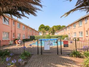 a gate with a pool in front of a building at Flat 18 in Paignton