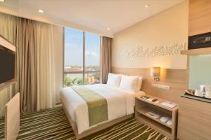 Postel nebo postele na pokoji v ubytování Holiday Inn Express Semarang Simpang Lima by IHG + 37 fotografií