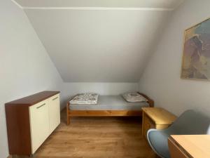 a small room with a bed and a desk at Uniejów PORT in Uniejow
