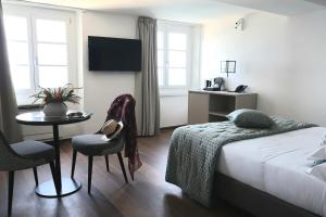 a hotel room with a bed and a table and chairs at Sublimis Boutique Hotel Adults-Only in Camogli