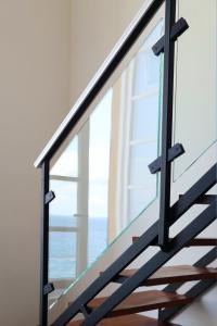 a glass staircase with a view of the ocean at Sublimis Boutique Hotel Adults-Only in Camogli