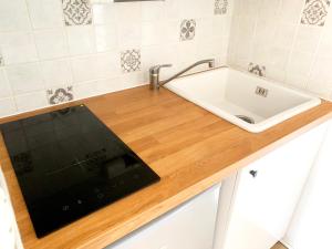 a kitchen with a sink and a tablet on a counter at Appartement avec balcon au pied des pistes de ski in Villarembert