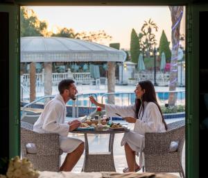 a man and woman sitting at a table eating food at Al Masa Hotel Nasr City in Cairo