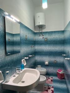 a bathroom with a sink and a toilet at La Casa Degli Agrumi in Trapani