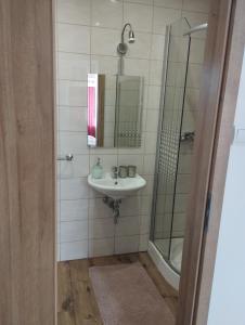 a bathroom with a sink and a shower at Hostinec pod úbočou in Valaská