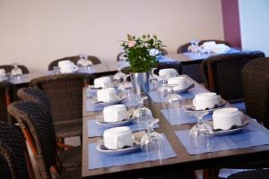 a long table with plates and wine glasses on it at Kyriad Paris 10 - Canal Saint Martin - République in Paris