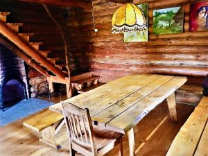 un tavolo in legno e una sedia in cabina di Poilsio namelis Plateliuose a Plateliai