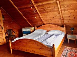 a bedroom with a wooden bed in a cabin at Poilsio namelis Plateliuose in Plateliai