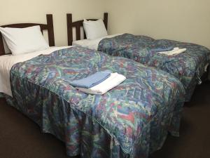 
Tempat tidur dalam kamar di Urban Hotel Morishita
