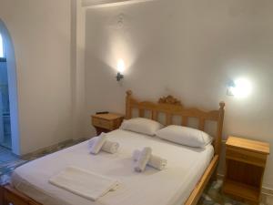 a bedroom with a bed with two towels on it at Anixi in Astypalaia