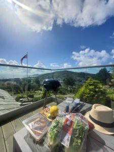 a table with a tray of vegetables on a balcony at Utsikten in Kalvåg +20 photos