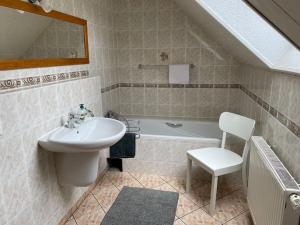 a bathroom with a sink and a bath tub at Behagliches Haus mit Kamin in Monschau +25 photos
