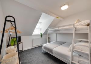 a bedroom with two bunk beds and a desk at Ellerby Lane House in Whitby