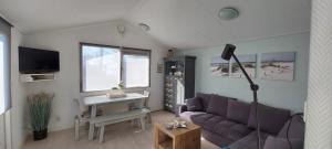 ein Wohnzimmer mit einem Sofa und einem Tisch in der Unterkunft Rekerlanden 253 in Schoorldam