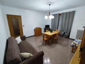 a living room with a couch and a table at Casa vacanza IL CORBETTO di Michela e Matteo in Locana