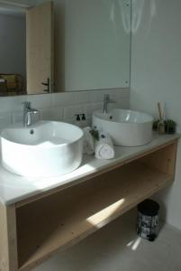 a bathroom with two sinks on a counter with a mirror at No. 9 Keurboom in Cape Town