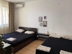 a bedroom with two beds and a window at Петрови in Chernomorets
