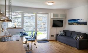 a living room with a couch and a table at Ferienwohnung Kerschbaumer in Gries am Brenner