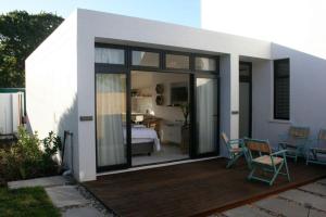 a room with a bedroom and a bed and a deck at No. 9 Keurboom in Cape Town