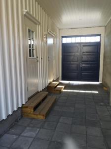 an empty hallway with a door and a tile floor at New 2 bed room apartment in Halden in Halden