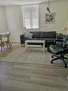 a living room with a couch and a table and chairs at New 2 bed room apartment in Halden in Halden