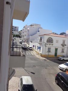 einen Balkon mit Blick auf eine Straße mit Autos in der Unterkunft Ténis Mar E in Albufeira