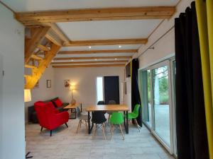 a living room with a wooden table and chairs at Bryziówka B in Miłków