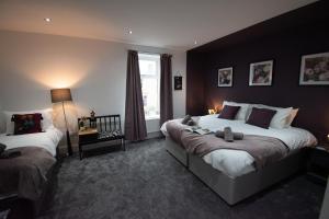 a bedroom with two beds and a window at Ideal Lodgings in Accrington in Accrington