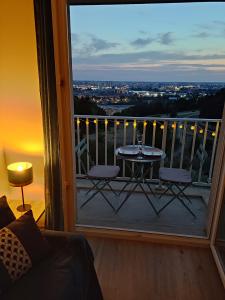 a view of a balcony with a table and chairs at Le panoramique - Parking, Tram A, Netflix in Cenon