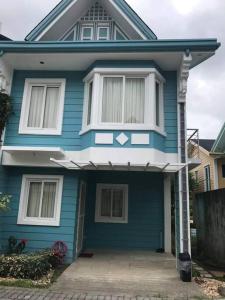 a blue house with a white window on it at 3 Bedrooms 3 Baths Victorian style Townhouse Fully Furnished in Batangas City