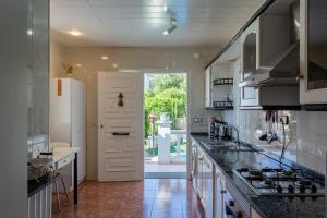 uma cozinha com um lavatório e um fogão forno superior em Villa Maria em Lloret de Mar