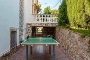 a ping pong table in the courtyard of a house at Villa Maria in Lloret de Mar