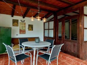 a dining room with a table and chairs at Luylyana Guesthouse in Ribarica