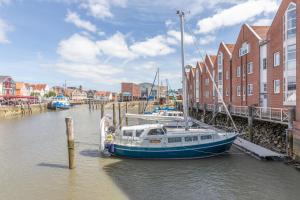 a boat is docked at a dock in the water at Hafenmeister in Husum