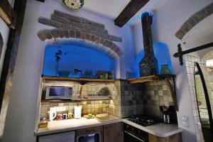 a kitchen with a stove and a microwave in a room at Medieval Super Studio in Vilnius