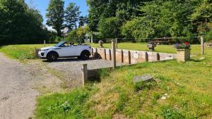 a white car parked on the side of a road at East Wing Apartment in Elgin in Elgin