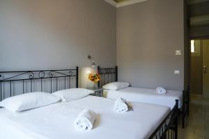 two beds in a room with white sheets at Affittacamere ALBA in Florence