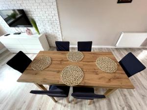 a wooden table with chairs and a dining room at Domek w górach in Barcice +8 photos