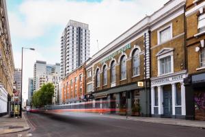 an empty city street with buildings and a streetcar at Bob W Commercial House in London