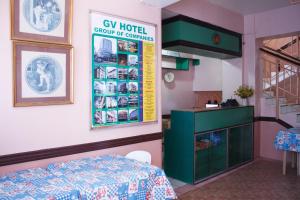 a room with a table and a sign on the wall at GV Hotel - Catarman in Catarman