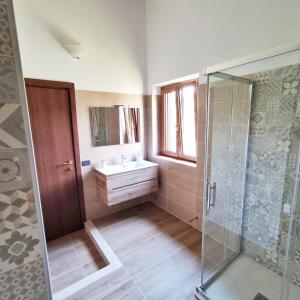 a bathroom with a sink and a glass shower at Villa Di Gioia in Caccuri