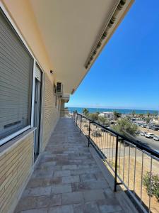 a balcony with a view of the beach at Casa Felix Ostia in Lido di Ostia