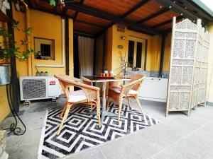 a patio with a table and chairs on a porch at Nadia's Lovely Home - WITH PRIVATE GARDEN AND JACUZZI in Florence