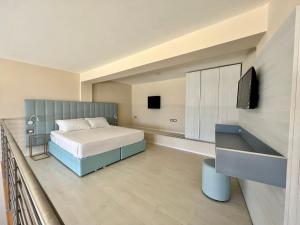 a bedroom with a bed and a flat screen tv at Toscana Sport Resort in Tirrenia +37 photos