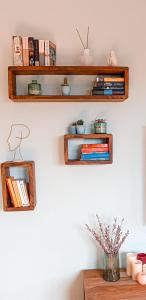 two wooden shelves on a wall with books at Auszeit auf 1000 m Höhe mit Familie & Hund in Neukirch