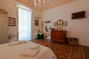 a bedroom with a bed and a tv and a window at B&B Il Melograno Taranto in Taranto
